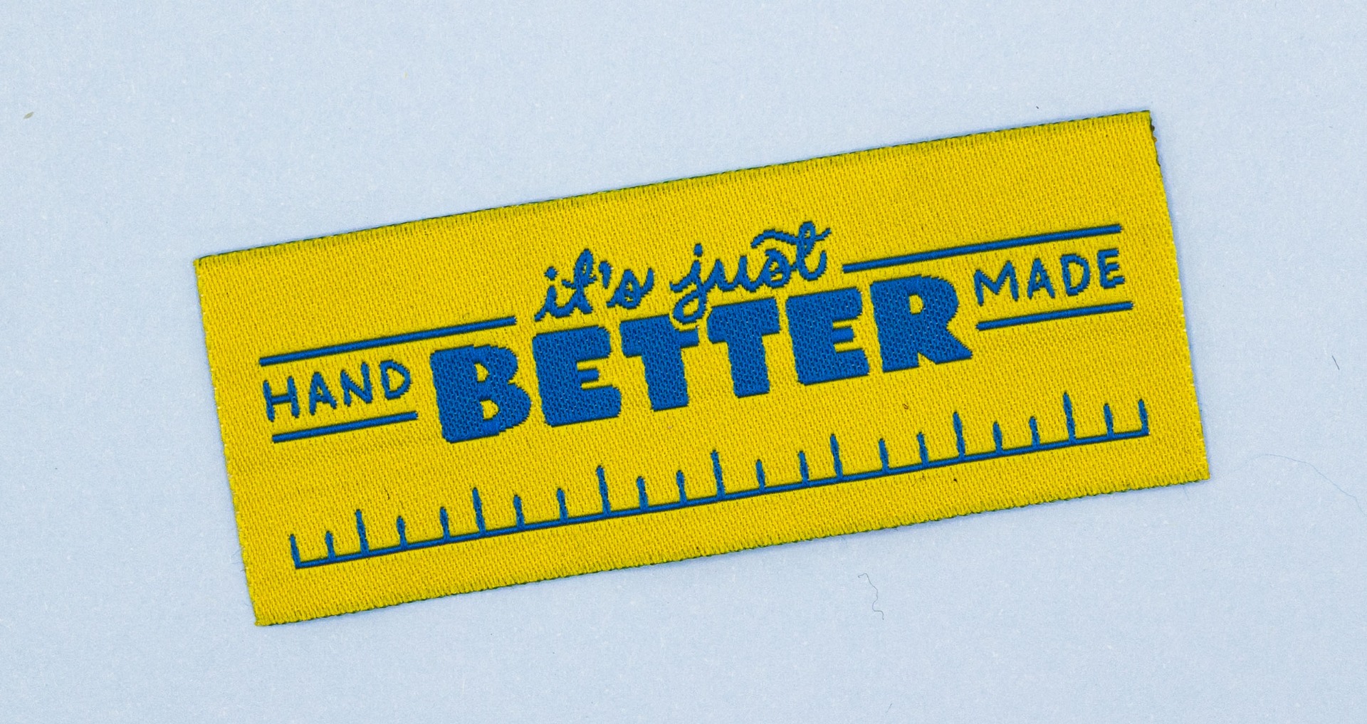 Close-up of woven fabric label showing durable thread construction and textile weave pattern