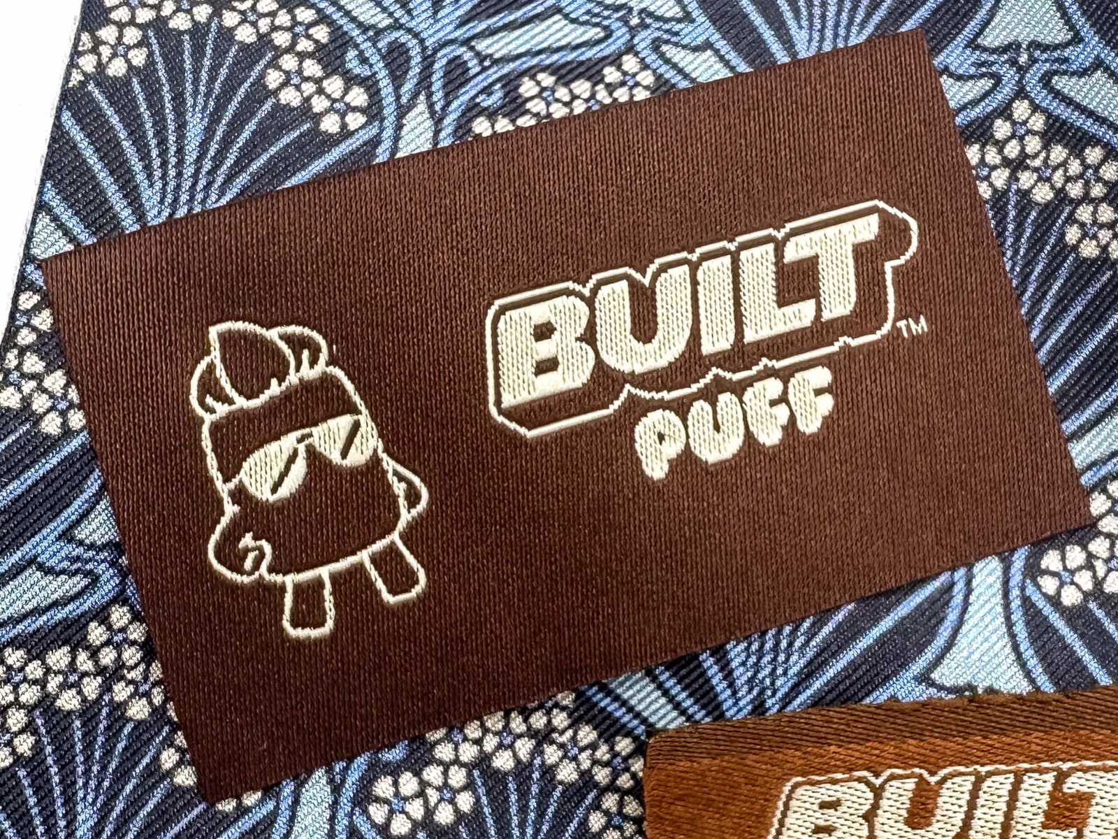High-quality custom woven labels showing crisp typography and professional thread texture with clean finished edges